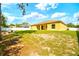 View of the back of house showing the yard and fire pit at 13216 Antelope St, Spring Hill, FL 34609