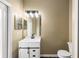 Bathroom featuring single vanity, black faucet, and large mirror at 13216 Antelope St, Spring Hill, FL 34609