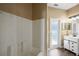 Well-lit bathroom featuring tub shower, white vanity with drawers and dark vinyl wood-look flooring at 13216 Antelope St, Spring Hill, FL 34609