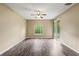 Bedroom with a ceiling fan, window, and sliding glass door at 13216 Antelope St, Spring Hill, FL 34609