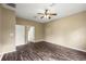 An empty bedroom features wood-look floors, neutral walls, ceiling fan, and closet at 13216 Antelope St, Spring Hill, FL 34609