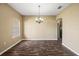 A dining room featuring wood-look floors, a window, and a hanging light fixture in a neutral color palette at 13216 Antelope St, Spring Hill, FL 34609