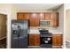 Kitchen features stainless steel appliances, dark cabinets, and modern countertops at 13216 Antelope St, Spring Hill, FL 34609