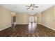 Spacious living room with dark wood floors and a ceiling fan at 13216 Antelope St, Spring Hill, FL 34609
