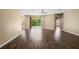 Spacious living room features wood-look floors, natural light, ceiling fan, and access to the outdoors at 13216 Antelope St, Spring Hill, FL 34609