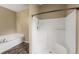 All white shower with corner seat and handheld shower fixture next to soaking tub at 13216 Antelope St, Spring Hill, FL 34609