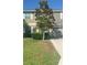 Charming two-story home featuring a well-maintained lawn and mature shade tree at 13752 Tensaw Dr, Hudson, FL 34669