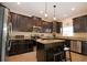 Modern kitchen featuring stainless steel appliances, granite countertops, and a functional island with breakfast bar at 13752 Tensaw Dr, Hudson, FL 34669