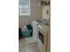 Functional laundry room with full-size washer and dryer, storage shelf, and natural light at 13752 Tensaw Dr, Hudson, FL 34669