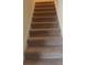 Carpeted stairway with white banister leads to the upper level of the home at 13752 Tensaw Dr, Hudson, FL 34669