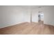 Well-lit living room with light-colored laminate flooring, freshly painted walls and an open floor plan at 1527 E Lake Ave, Tampa, FL 33610