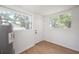 Bright mud room features wood floors, white walls and trim, and natural light through two windows at 1527 E Lake Ave, Tampa, FL 33610