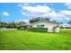 Well-maintained backyard featuring a lush lawn, privacy hedges, and a serene outdoor space at 2132 Sandpiper Dr, Clearwater, FL 33764
