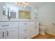 A modern bathroom featuring a double vanity, toilet, and shower, providing a clean and functional space at 2132 Sandpiper Dr, Clearwater, FL 33764