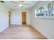 Sunlit bedroom with wood-look floors, closet and en-suite bathroom at 2132 Sandpiper Dr, Clearwater, FL 33764