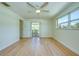 Bright bedroom showcasing new floors, a window, and access to a screened patio for indoor-outdoor living at 2132 Sandpiper Dr, Clearwater, FL 33764