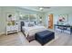 A staged bedroom with stylish furniture, lamps, and artwork offers a comfortable and inviting space at 2132 Sandpiper Dr, Clearwater, FL 33764