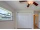 An empty bedroom features a closet, window, and light-colored walls, offering a blank canvas for personalization at 2132 Sandpiper Dr, Clearwater, FL 33764