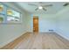 Bedroom with wood floors, bright light, and access to a bathroom at 2132 Sandpiper Dr, Clearwater, FL 33764