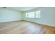 Spacious bedroom featuring wood-look flooring and a large window for ample natural light at 2132 Sandpiper Dr, Clearwater, FL 33764