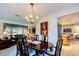 Bright dining room with elegant chandelier, hardwood table, and open view to living room at 2132 Sandpiper Dr, Clearwater, FL 33764