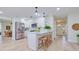Bright kitchen with stainless steel appliances, breakfast bar, and hardwood floors at 2132 Sandpiper Dr, Clearwater, FL 33764