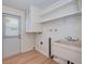 This laundry room features a utility sink, built-in storage, shelving, and a door to the outside at 2132 Sandpiper Dr, Clearwater, FL 33764