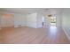 Open living area with wood-look flooring, neutral walls, and access to outdoor space at 2132 Sandpiper Dr, Clearwater, FL 33764