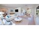 Bright, open living room featuring stylish furniture, hardwood floors, and abundant natural light at 2132 Sandpiper Dr, Clearwater, FL 33764