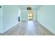Spacious living room features wood floors and access to kitchen and outdoor space at 2132 Sandpiper Dr, Clearwater, FL 33764