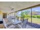 Covered patio with dining table and chairs overlooking the lush backyard at 2132 Sandpiper Dr, Clearwater, FL 33764