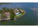 Stunning aerial view of waterfront home with a private pool, dock, and lush landscaping on a sunny day at 218 Colony Point S Rd, St Petersburg, FL 33705