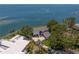 Aerial view of a charming waterfront estate with lush trees and meticulous landscaping at 218 Colony Point S Rd, St Petersburg, FL 33705