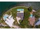 Aerial view showcasing multiple waterfront homes, private pools, lush landscaping, and deep water access at 218 Colony Point S Rd, St Petersburg, FL 33705