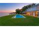 Expansive backyard features a large private pool and covered lanai with water view at 218 Colony Point S Rd, St Petersburg, FL 33705