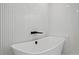 Modern bathroom showcasing a freestanding tub with sleek black fixtures and textured white walls at 218 Colony Point S Rd, St Petersburg, FL 33705