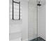 Sleek bathroom featuring a glass-enclosed shower with white textured tiles and blue geometric floor at 218 Colony Point S Rd, St Petersburg, FL 33705