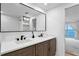 Modern bathroom featuring a double sink vanity with a large mirror, and views to the ocean at 218 Colony Point S Rd, St Petersburg, FL 33705