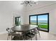 Bright dining room features stylish lighting, modern furniture, and waterfront views with access to the outdoor area at 218 Colony Point S Rd, St Petersburg, FL 33705