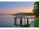 Private dock with boat lift provides direct water access at sunset at 218 Colony Point S Rd, St Petersburg, FL 33705