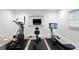 Home gym featuring an elliptical, stationary bike, and rowing machine for a complete workout at 218 Colony Point S Rd, St Petersburg, FL 33705