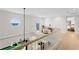 Upstairs hallway with a sitting area, an octagonal window with water views, and a modern chandelier at 218 Colony Point S Rd, St Petersburg, FL 33705