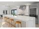 Bright kitchen featuring a waterfall island, modern stainless appliances, and views of the water at 218 Colony Point S Rd, St Petersburg, FL 33705