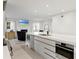 Modern kitchen featuring a waterfall island, stainless steel appliances, and an open view to the living area at 218 Colony Point S Rd, St Petersburg, FL 33705