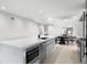 Modern kitchen featuring a waterfall island, stainless steel appliances, and an open view to the dining area at 218 Colony Point S Rd, St Petersburg, FL 33705