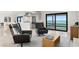 Bright living room with modern furniture, an open kitchen, and a view of the pool and water at 218 Colony Point S Rd, St Petersburg, FL 33705
