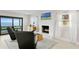 Cozy living room with a white brick fireplace, comfortable seating, and a sliding door to the outside at 218 Colony Point S Rd, St Petersburg, FL 33705