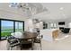 Open floor plan features a dining area, chef's kitchen, and seating area with a fireplace and waterfront views at 218 Colony Point S Rd, St Petersburg, FL 33705