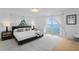 Light and airy main bedroom featuring white walls, access to the ocean view, and stylish decor at 218 Colony Point S Rd, St Petersburg, FL 33705