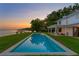 Sparkling in-ground pool set in a lush yard, adjacent to calm waters; perfect for outdoor living at 218 Colony Point S Rd, St Petersburg, FL 33705